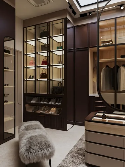 A dedicated, backlit cabinet for handbags and shoes turns everyday items into a beautiful display. The plush faux-fur bench adds a layer of softness and comfort.