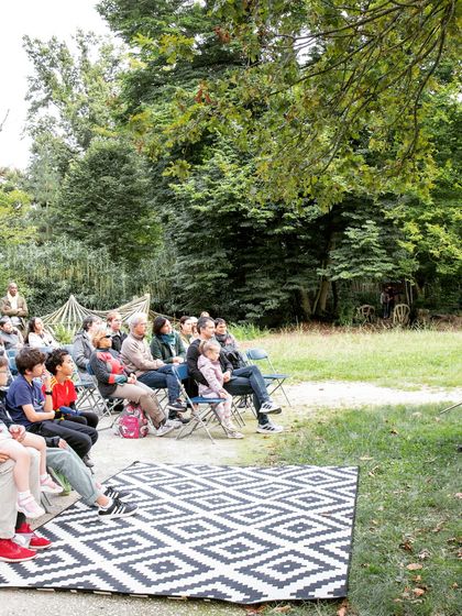A wide view of our audience enjoying the outdoor performance of 'Pajarillo Verde'. We create a relaxed and welcoming atmosphere for families to experience live music together.