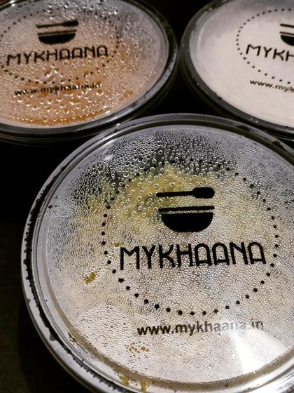 Your hot meal arrives in our branded, spill-proof containers. The condensation on the lid is a sign of the fresh, warm food waiting inside, ready to be enjoyed.