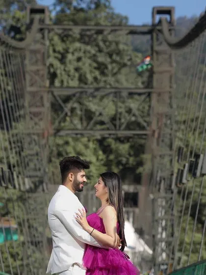 An intimate portrait on a suspension bridge in Rishikesh. The bridge symbolizes connection and a journey forward, making it a powerful location for a pre-wedding photo that is both beautiful and meaningful.