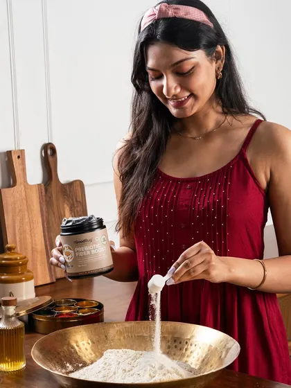 We integrate products into familiar home settings. Here, The Good Bug's supplement is shown being added to flour in a kitchen, suggesting its use in healthy baking.