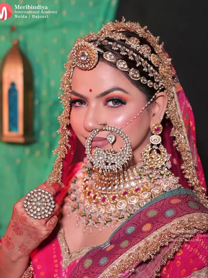 Mastering traditional bridal hairstyling is a key to success. This Rajasthani bridal look showcases intricate hair work, including the placement of a traditional matha patti and a heavily jeweled nath, complementing the overall regal aesthetic.
