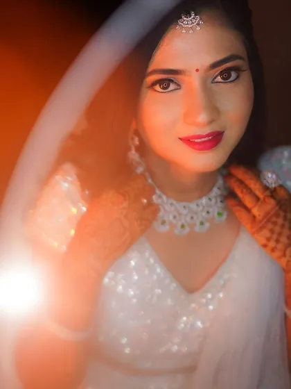 A dreamy, soft-focus shot of Rakshita's reception look, highlighting her radiant skin and sparkling lehenga.