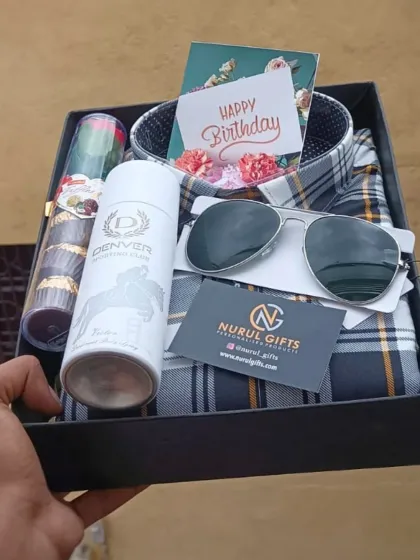 Celebrate his birthday with this thoughtful hamper. It includes a stylish checkered shirt, aviator sunglasses, Denver deodorant, chocolates, and a "Happy Birthday" card.