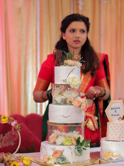 Another look at my five-tier engagement cake. It featured separator tiers with lights and flowers, a technique I love using for grand celebrations.