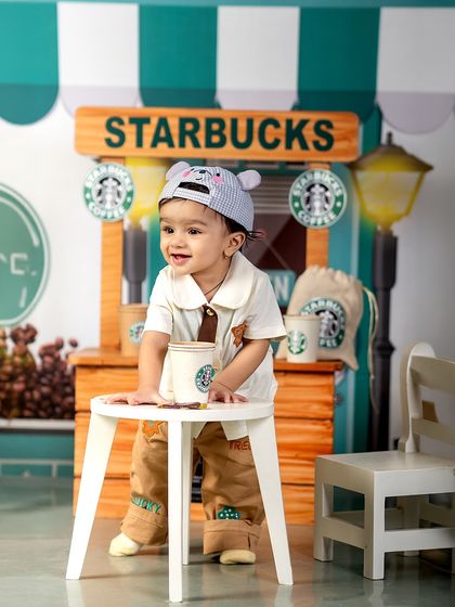 Because cafes are better with a little extra giggle. This little barista, with his adorable bear hat, is ready to take your order at the mini Starbucks stand.