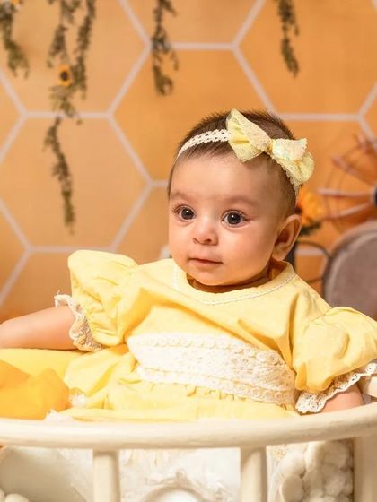 A sweet newborn sleeping in a basket as part of our sunflower and bee theme, showing how I can incorporate themes even for the tiniest clients.