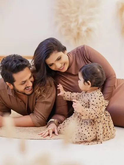 A playful moment on the floor during a family milestone session. I encourage natural interactions to capture authentic moments of love and laughter.