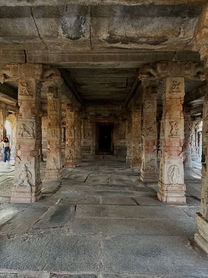 The carved pillars of a temple hall in Hampi. Each carving tells a story from Hindu mythology, embedding philosophy and the principles of dharma into the very stone of the land.