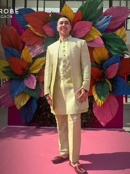 Posing against a colorful backdrop, this renter is wearing a lime-green Indo-western jacket over a kurta. This shows how my outfits can make you pop in photos.