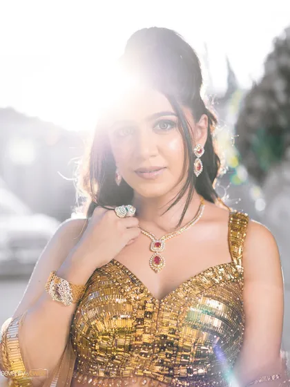 A beautiful sun-flared portrait of the bride. Her golden dress seems to melt into the light, creating a dreamy, ethereal image.