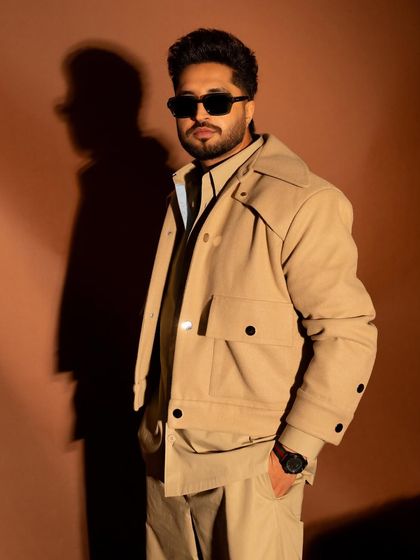 A three-quarter portrait where the lighting creates a strong shadow, adding depth to the image.