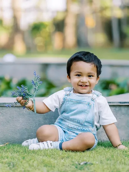 Another shot of the birthday boy in his cute overalls, enjoying the fresh air and flowers during his outdoor session.