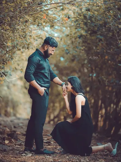 A romantic pose in a beautiful, secluded forest path. The way the trees form an arch creates a natural frame for this intimate moment.