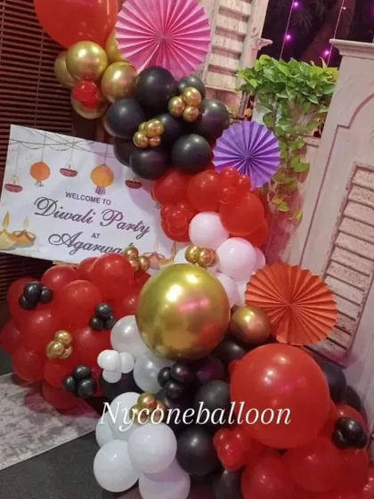 A festive entrance for a Diwali party. This balloon arrangement in red, black, and gold, along with a personalized welcome sign, sets a celebratory mood right from the door.