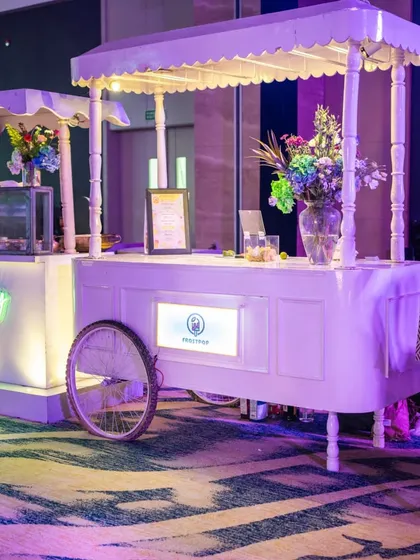 Quirky and elegant food stalls designed for the Sangeet. We used clean white carts with custom branding and neon signs to create stylish and functional service points for guests.