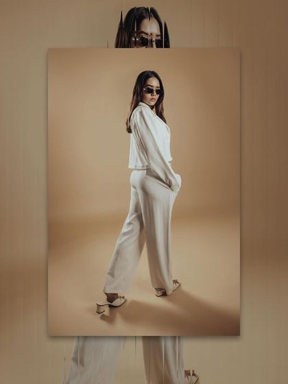 This image showcases a full-body pose. The makeup needs to be strong enough to be visible and impactful even in a wider shot.