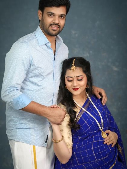 This couple chose a traditional South Indian theme for their maternity shoot, and the result was absolutely stunning. The rich blue saree and veshti create a classic look.