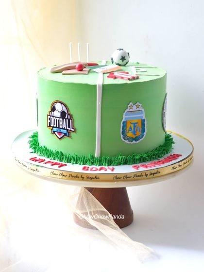 A side view of the football-themed cake, showing the different team logos.