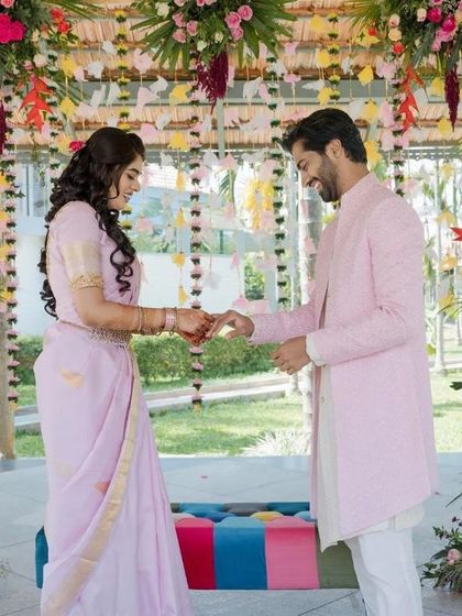 Capturing the beginning of a lifelong promise. The soft pastel outfits of the couple are beautifully complemented by the rich tones of the floral decor.