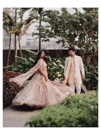 The bride-to-be, Aayushi, twirls in her flowing floral lehenga. This shot is all about capturing the beauty and movement of the outfit, making her look and feel like she's in a fairytale.