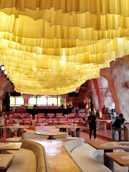 The venue before the party, with a ceiling of yellow fabric creating a sunny, beach-like atmosphere.