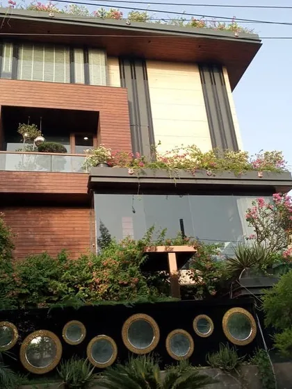 The facade of this modern Noida home is softened with greenery at multiple levels. I installed planters on the first-floor ledge and the rooftop to ensure the entire building feels connected to nature.
