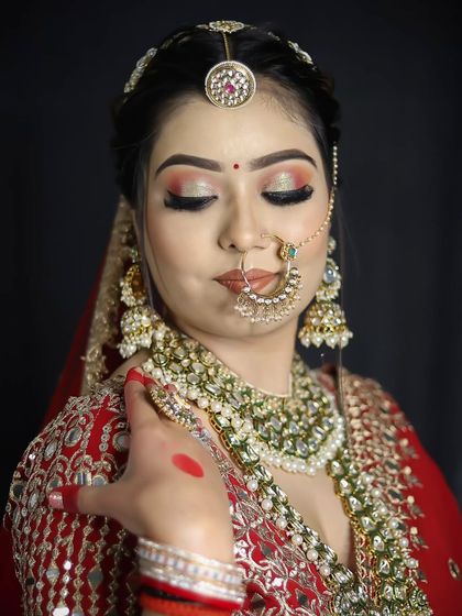 A close-up of a traditional bridal look, showing the detailed eye makeup with a sharp cut crease and shimmering lid.