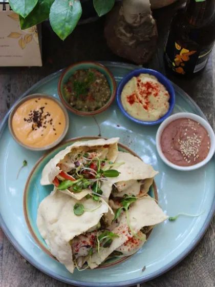 Our Pita Platter is a delightful treat for Lebanese cuisine lovers. It features perfectly baked falafels, fresh fattoush salad, bean hummus, and spicy vegan cheese, all served in our in-house pita pockets.