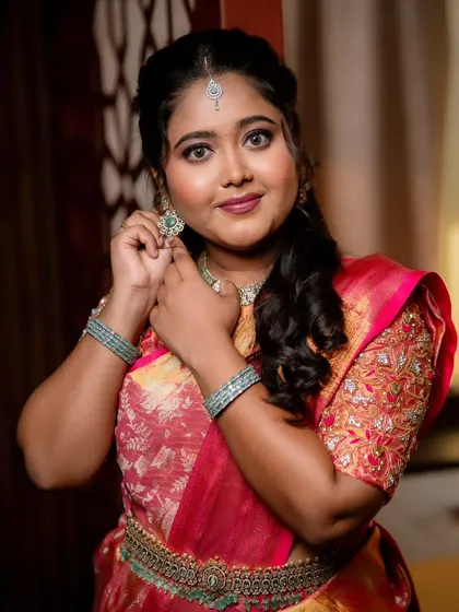 A beautiful bride getting ready for her reception, adjusting her earrings.