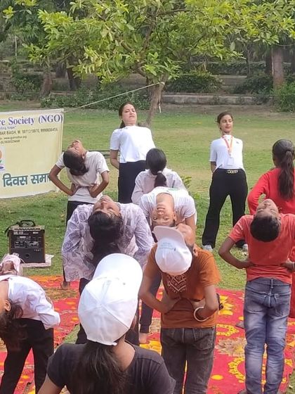 Guiding the children through Ardha Chakrasana (Half Wheel Pose). These simple backbends are excellent for improving flexibility of the spine and opening up the chest.