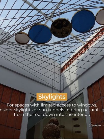 This image highlights the use of skylights to bring natural light into interior spaces that have limited access to windows. The circular colored glass adds an artistic touch to the light.