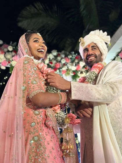 The happy couple sharing a laugh during their Jaimala ceremony in Goa. The joy of a destination wedding is infectious.