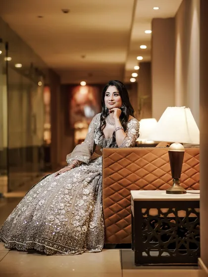 A solo portrait of the bride-to-be, looking elegant and thoughtful in her beautiful engagement lehenga.