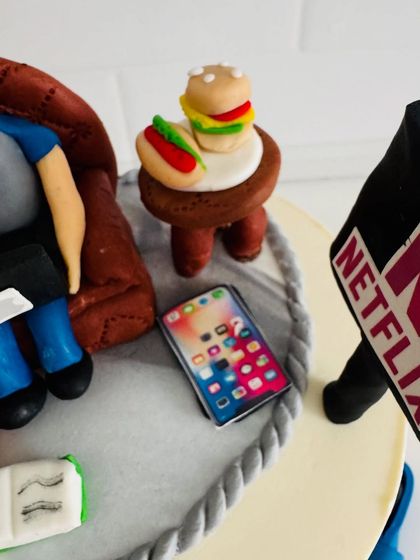 The little details matter most. A close-up of the tiny fondant hotdog, burger, and iPhone on this custom 50th birthday cake.