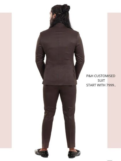 A view from the back of the classic brown suit, showcasing the expert tailoring and fit.