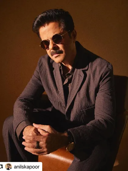 A moody, stylish shot of Anil Kapoor. The lighting highlights the texture and layers in his hair.