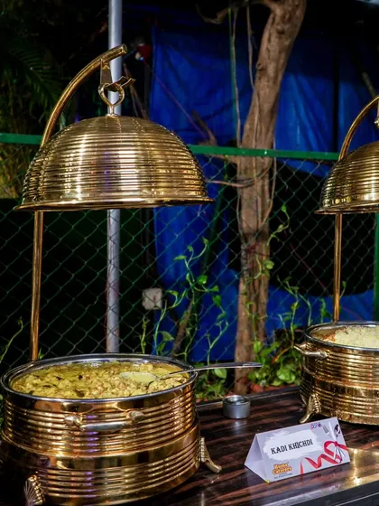 Our stunning brass serveware with elegant cloche lids, keeping the food warm while adding a touch of royalty to the buffet line.