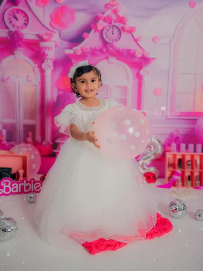 This little Barbie is ready to party. The all-pink setup with balloons and disco balls created the perfect atmosphere for her second birthday photos.