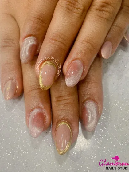 The perfect example of subtle glamour. This set features a soft, milky white ombré on a natural base, with a delicate gold chrome line tracing the cuticle of the accent nails for a touch of modern elegance.