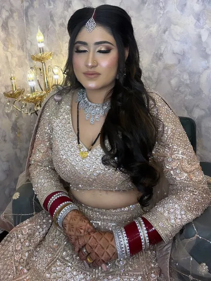 The full reception look, complete with a sparkling lehenga and diamond jewellery. The makeup is designed to complement the entire outfit, creating a stunning and cohesive appearance.