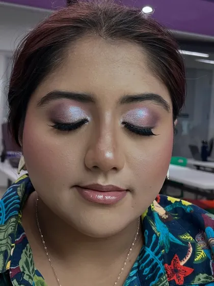 A different demo look featuring iridescent lilac and pink eyeshadow, showing students how to play with color.