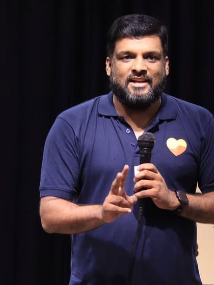 A host addresses the audience, welcoming them to the show.