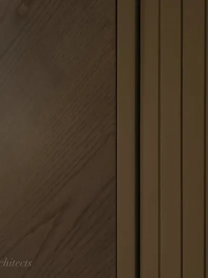 A detailed shot of the veneer and fluted paneling on the hidden bar cabinet. The precise craftsmanship and quality of the materials are what make a bespoke piece like this truly special.