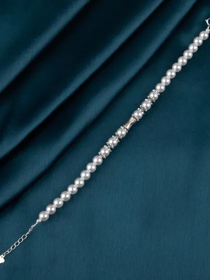 A full view of a pearl and silver bead bracelet.