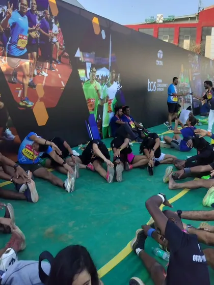 This is the aftermath of a great race day at the TCS 10K. After the run, we immediately get into our post-race stretching and mobility routine. This is a critical part of our injury prevention strategy and helps us recover faster for the next training session.