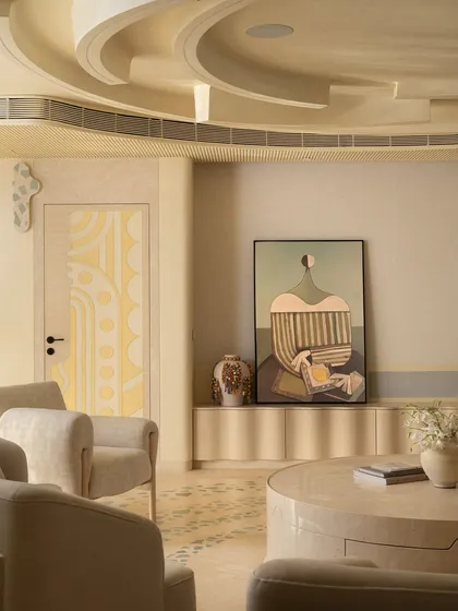 A view of the living area in the 'Soft Serve' apartment, showing the custom-painted door with geometric patterns and the sculptural ceiling. The design is based on 'Seijaku,' a Japanese concept of tranquility in the midst of a bustling city.
