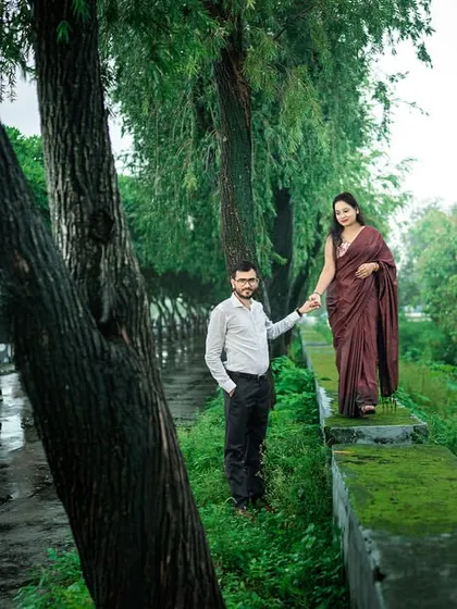 A walk through a lush, green path after the rain. The vibrant colors of nature and the romantic mood make this a beautiful and refreshing pre-wedding photo.