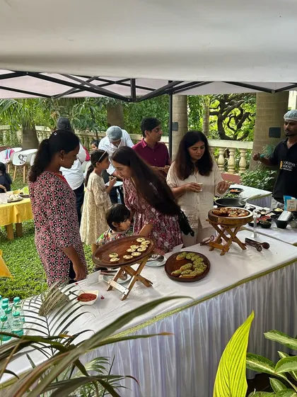 Guests gathering around the food station at an outdoor birthday party. My team is always on hand to serve and assist, making the experience seamless for the host.