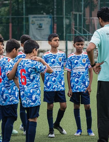 The U13 team gets a pep talk from the coaches. Strategy and communication are key elements we teach in our competitive youth football programs.